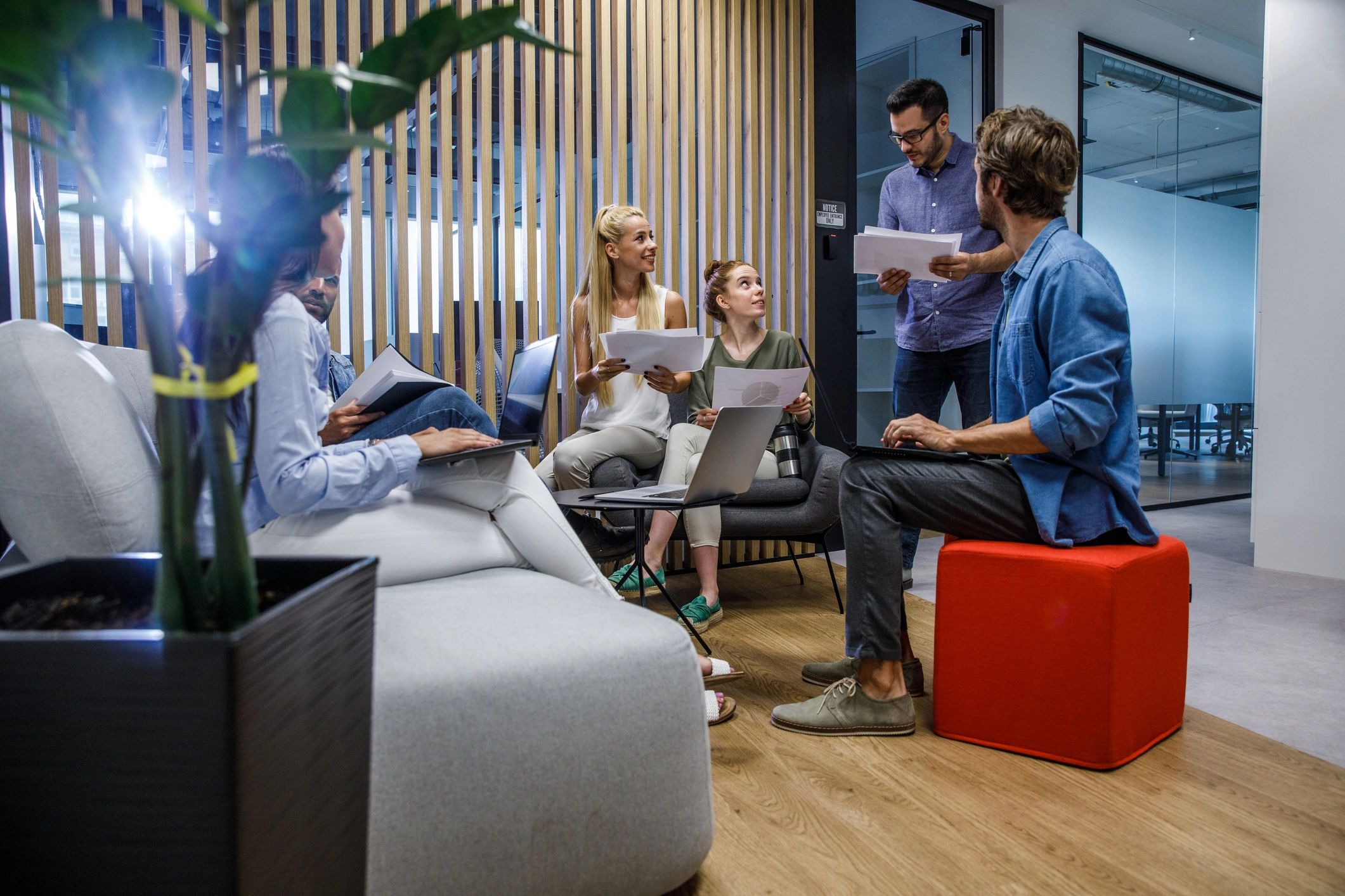 Team briefing in an office lounge area