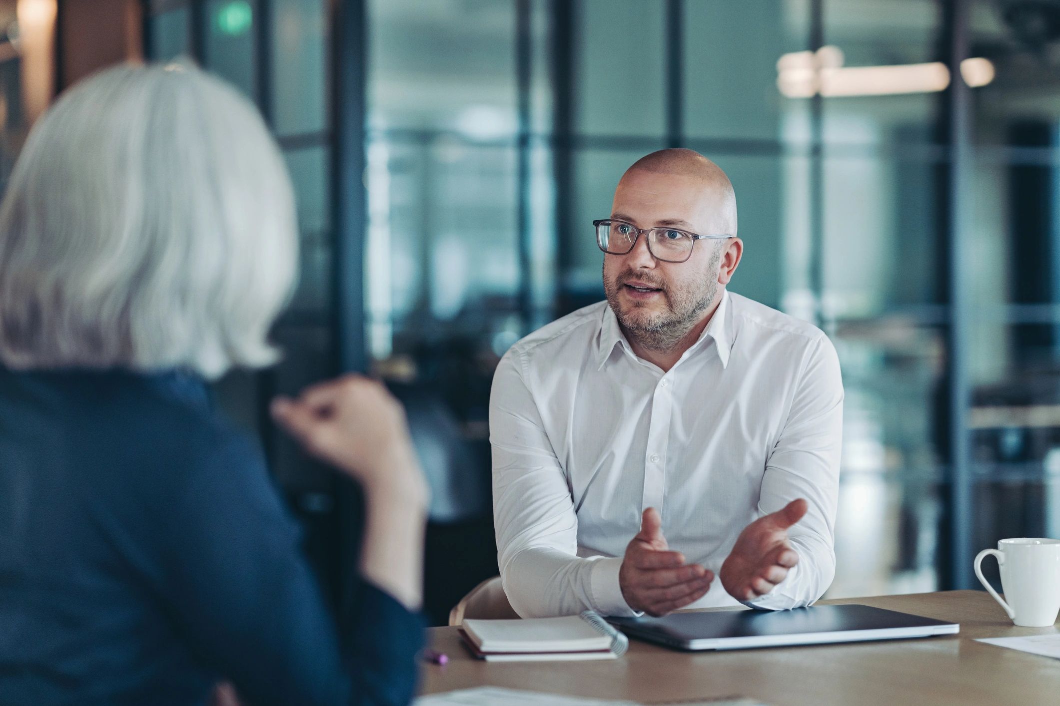 Financial advisor speaking with a client in an office
