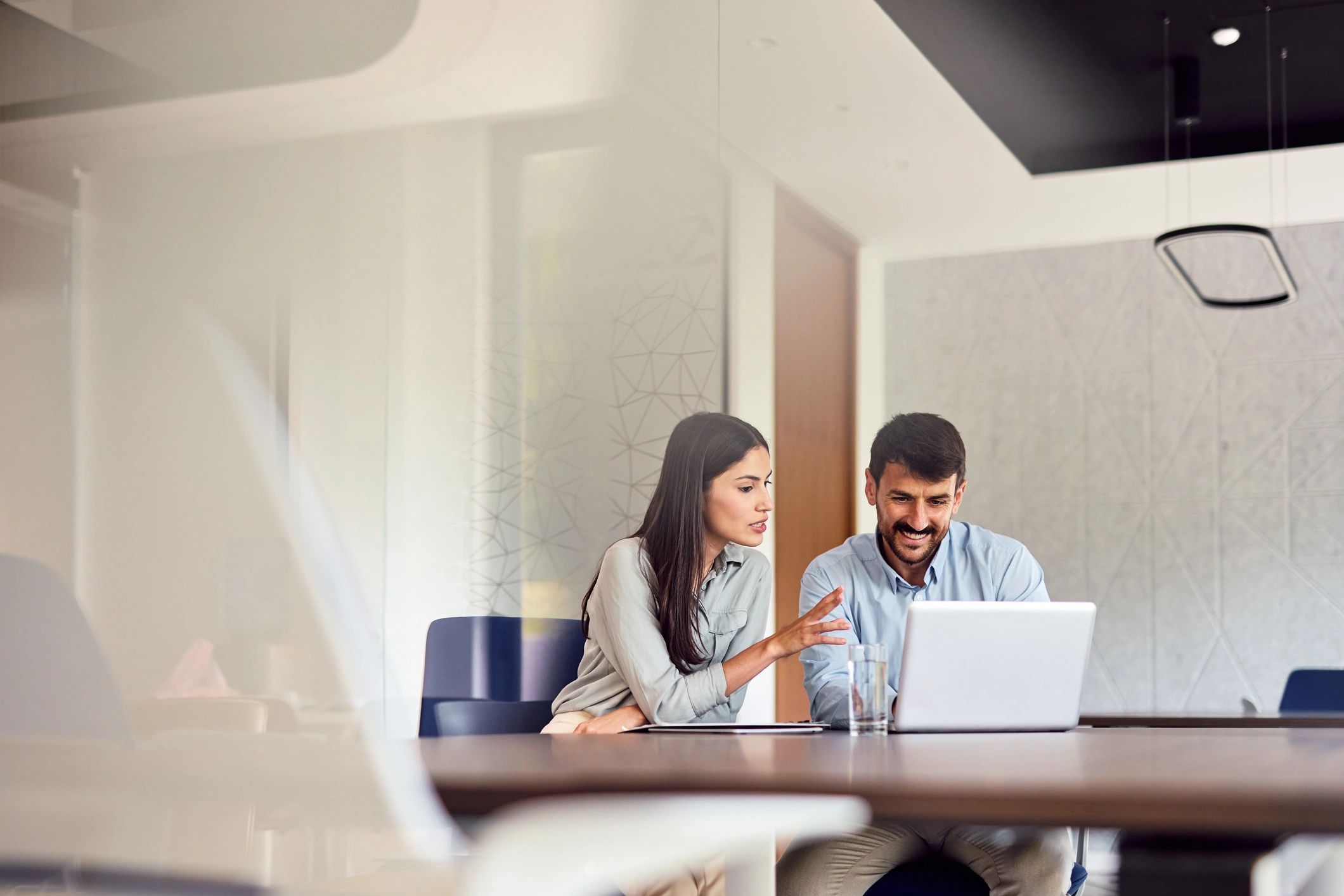 Advisor meeting with a client in a modern office